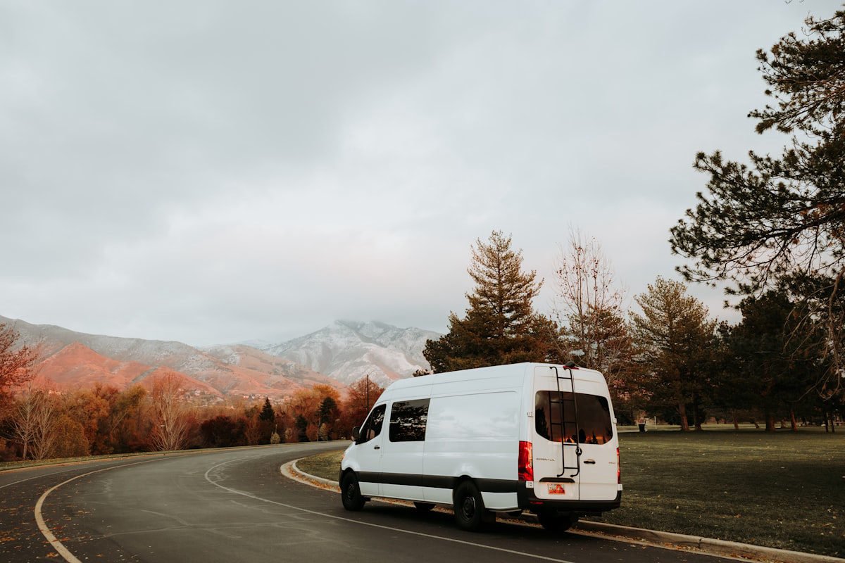 Minibus on a winding road through the Romanian countryside